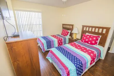 a room with two beds with polka dots at Sweetwater Club 3 Bedroom Condo Resort Pool 9 Miles to Disney in Kissimmee