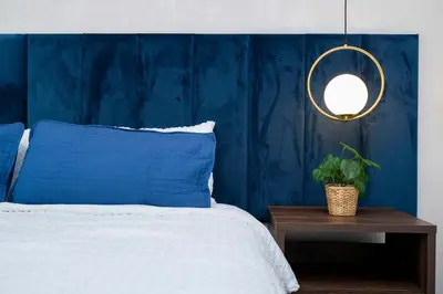 a blue bedroom with a bed and a mirror at 2681 Stunning home perfect for your family in Kissimmee