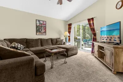 a living room with a couch and a flat screen tv at 1061 Lake Berkley 4 Bed with Pool&Spa in Kissimmee