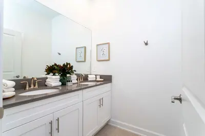 a bathroom with a sink and a large mirror at Luxurious Home w Theme Beds & Private Pool in Kissimmee