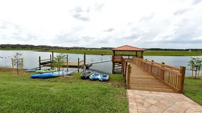 a dock with a bunch of boats on the water at Storey Lake 6BR Cozy Home Private Pool Near Disney in Kissimmee