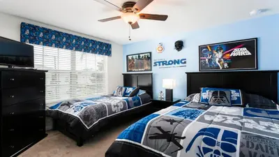 a bedroom with two beds and a ceiling fan at Windsor Hills 6br Cozy Home Pool/Spa 2miles Disney in Orlando