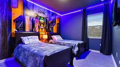 a bedroom with two beds and purple lights at Opulent Retreat, Pool & Lake View, Near Parks in Kissimmee
