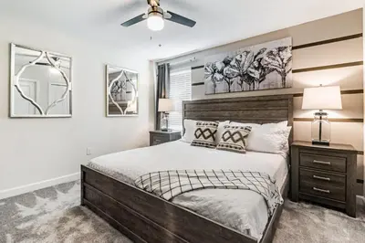 a bedroom with a bed and a ceiling fan at Family Reunion 10BR Villa Pool/SPA Near Disney! in Kissimmee