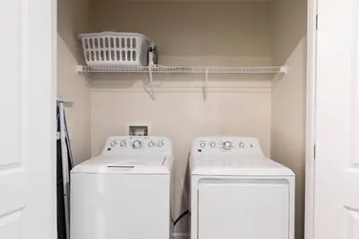 a kitchen with two white appliances and a shelf at Family Reunion 10BR Villa Pool/SPA Near Disney! in Kissimmee