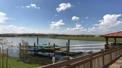a dock with two boats on the water at Family Reunion 10BR Villa Pool/SPA Near Disney! in Kissimmee