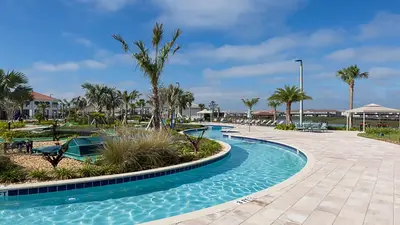 a swimming pool at a resort with palm trees at Family Reunion 10BR Villa Pool/SPA Near Disney! in Kissimmee