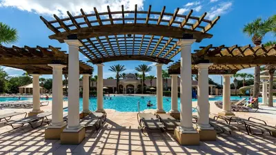 a pool at the resort with chairs and a pavilion at Windsor Hills 5br Private Pool, Near Disney in Orlando