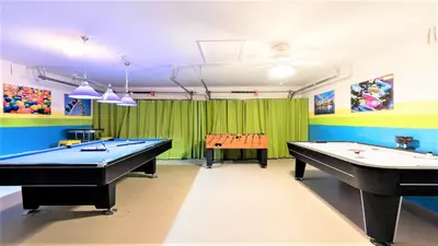 two pool tables in a room with green curtains at Windsor Hills 5br Private Pool, Near Disney in Orlando