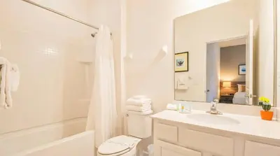a bathroom with a sink and a toilet and a shower at Spacious 12-Bed Villa with Pool & Resort Amenities in Kissimmee