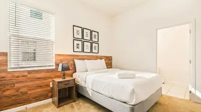 a bedroom with a large bed and a window at Spacious 12-Bed Villa with Pool & Resort Amenities in Kissimmee
