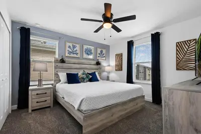 a bedroom with a bed and a ceiling fan at Lakeview Villa Near Disney with Pool & Resort in Kissimmee