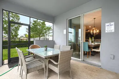 a dining room with a table and chairs at Lakeview 6BR Cozy Home Pool/SPA,Steps to Waterpark in Kissimmee