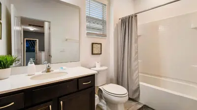 a bathroom with a toilet and a sink and a shower at Veranda Palms Lakeview 6br Villa Pool Spa, Disney in Kissimmee