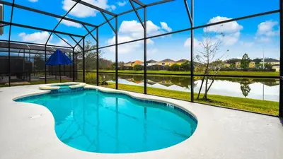 a swimming pool in a building with a large window at Veranda Palms Lakeview 6br Villa Pool Spa, Disney in Kissimmee