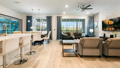 a living room with a kitchen and a dining room at Veranda Palms Lakeview 6br Villa Pool Spa, Disney in Kissimmee