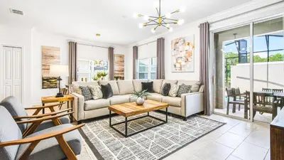 a living room with a couch and a table at Storey Lake 5br Family Townhome w Pool Near Disney in Kissimmee