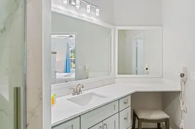 a white bathroom with a sink and a mirror at The Epic London Vista Cay Orlando Next to the club in Orlando