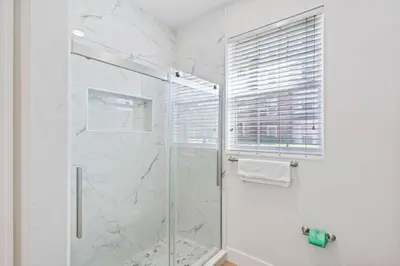 a bathroom with a shower with a glass door at The Epic London Vista Cay Orlando Next to the club in Orlando