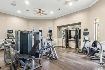 a gym with several treadmills and exercise machines at The Epic London Vista Cay Orlando Next to the club in Orlando