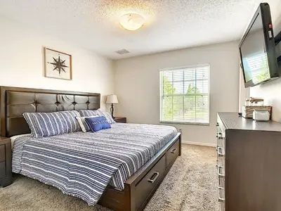 a bedroom with a bed and a television in it at 3 Bedroom Townhome Close to Disney in Kissimmee