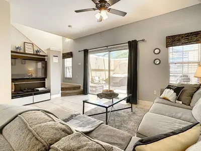 a living room with a couch and a table at 3 Bedroom Townhome Close to Disney in Kissimmee
