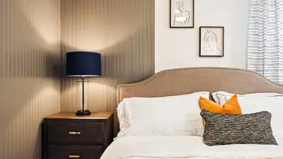 a bedroom with a bed with a lamp on a night stand at Storey Lake 9BR Lakeview Home Pool/SPA/Game Disney in Kissimmee