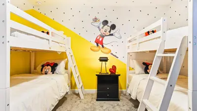 two bunk beds in a room with yellow walls at Storey Lake 9BR Lakeview Home Pool/SPA/Game Disney in Kissimmee