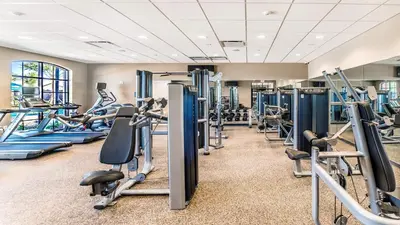 a gym with treadmills and cardio machines at Storey Lake 9BR Lakeview Home Pool/SPA/Game Disney in Kissimmee