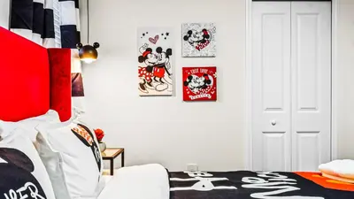 a bedroom with a bed with posters on the wall at Themed Rooms & Pool in Storey Lake Resort in Kissimmee