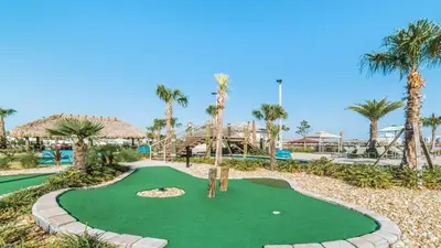 a golf course at the resort with palm trees at Cozy Home Storey Lake Resort Pool Spa Near Disney in Kissimmee