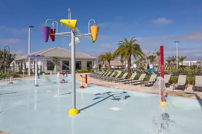 a pool with a water park with a water fountain at Storey Lake 10BR Home Pool/SPA/Game Room,GreenView in Kissimmee
