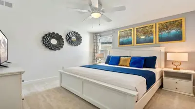 a bedroom with a bed and a ceiling fan at Storey Lake 10BR Home Pool/SPA/Game Room,GreenView in Kissimmee