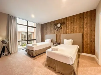 a hotel room with two beds and a window at 3059 Luxury And Relaxation Just 1 Mile From Disney in Orlando