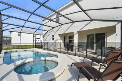 a swimming pool with a glass roof on a patio at Mario 12BR Villa w/ Private Green View Pool in Kissimmee