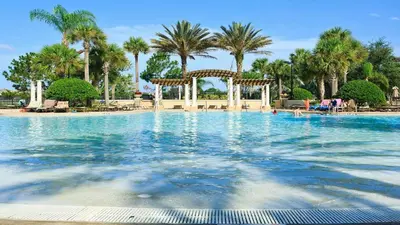 a large swimming pool with a gazebo and palm trees at Cozy 6br Home w/ Private Pool Spa in Windsor Hills in Orlando