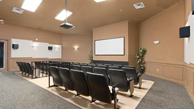 a conference room with black chairs and a screen at Cozy 6br Home w/ Private Pool Spa in Windsor Hills in Orlando