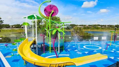 a water park with a slide in a pool at Firework view 6BR Home Pool/Spa/Game Near Disney! in Orlando