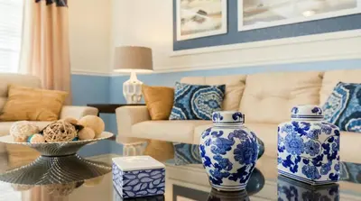 a living room with blue and white vases on a table at Firework view 6BR Home Pool/Spa/Game Near Disney! in Orlando
