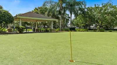 a sign in the middle of a field of grass at No Rear Neighbor 6BR Private Pool/Spa Near Disney in Orlando