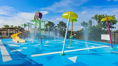 a pool with a water park with a water fountain at No Rear Neighbor 6BR Private Pool/Spa Near Disney in Orlando