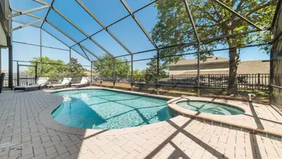 a swimming pool in a building with a glass ceiling at Windsor Hills 6BR Villa Pool/SPA Close to Disney in Orlando