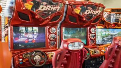 a bunch of video games on a pinball machine at Highland View 6BR Villa Private Pool Near Disney in Orlando