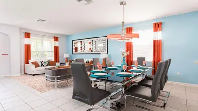 a dining room and living room with a table and chairs at Windsor Hill 6BR South-facing Pool/Spa Near Disney in Orlando
