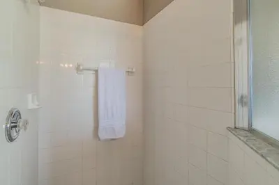 a bathroom with a towel hanging on a shower at Santee Villa in Kissimmee