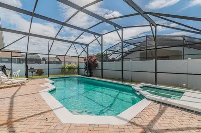 a swimming pool with a glass roof on a building at Santee Villa in Kissimmee