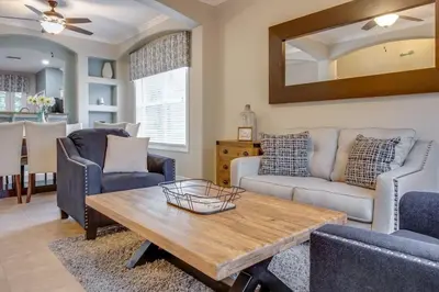 a living room with couches and a table at Emerald Escape in Kissimmee