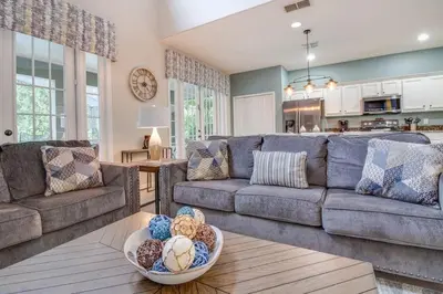 a living room with a couch and a table at Emerald Escape in Kissimmee