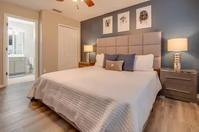 a bedroom with a large bed and two lamps at Emerald Escape in Kissimmee