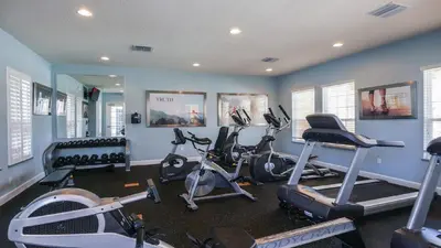 a gym with several exercise bikes in a room at 3 bedrooms pool home Retreat Close to Disney in Orlando